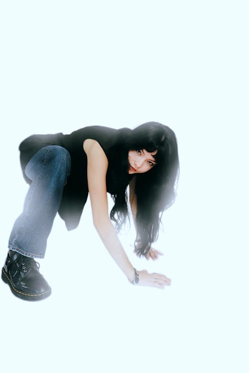 Woman with Black Hair Squatting and Posing