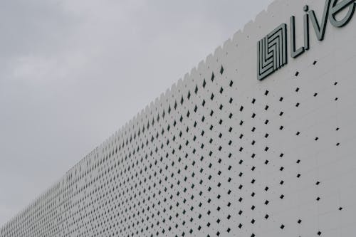 Pattern and Logo on White Building Wall