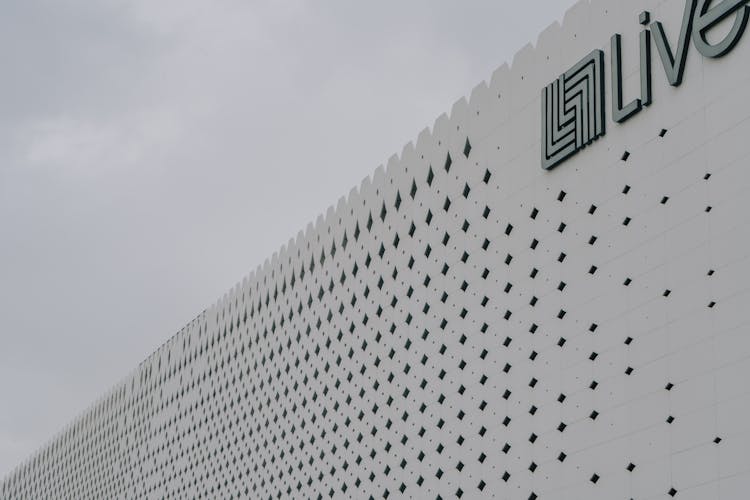 Pattern And Logo On White Building Wall