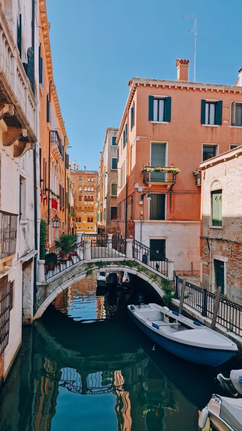 Free Charming view of a canal in Florence, Italy with vibrant buildings and a serene waterway. Stock Photo