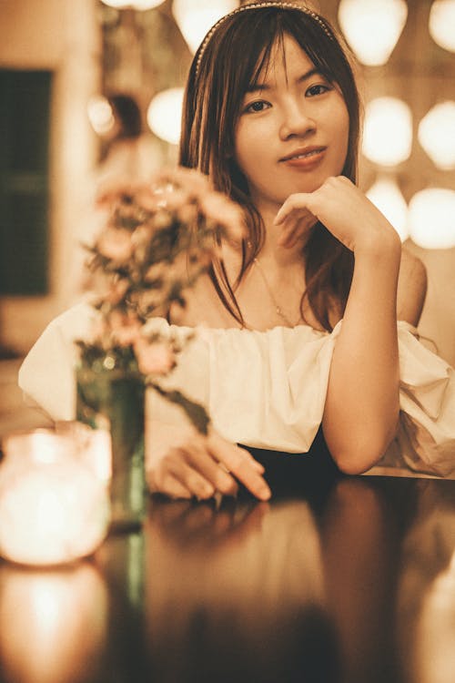 Woman Sitting by Table