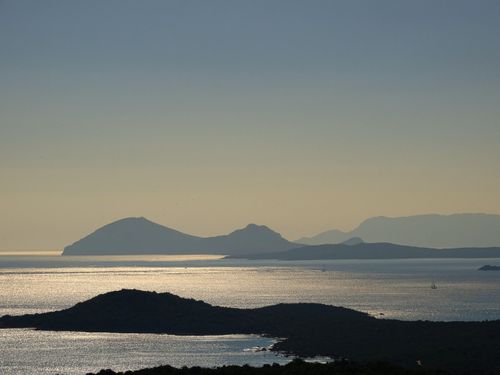 Free Peaceful dusk over shimmering sea and silhouetted islands in a tranquil landscape. Stock Photo