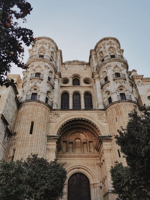 Free Gothic-style facade of the historic Malaga Cathedral viewed in vertical shot, Spain. Stock Photo