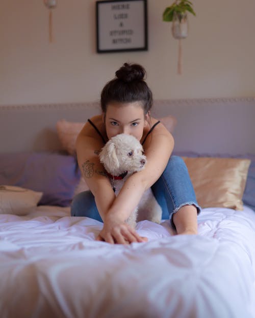 Woman with Dog on Bed
