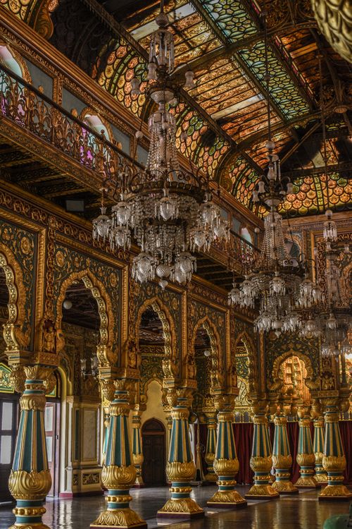 Free Stunning view of the golden and intricate interiors of Mysore Palace showcasing chandeliers and columns. Stock Photo