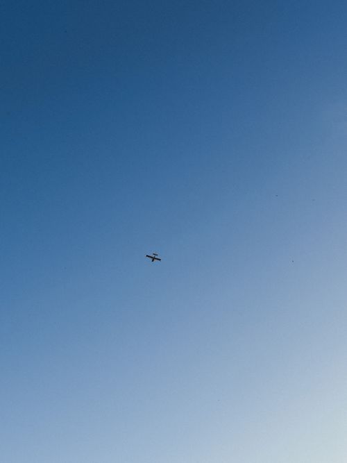 Free A plane glides effortlessly through a vast and clear blue sky offering ample copy space. Stock Photo