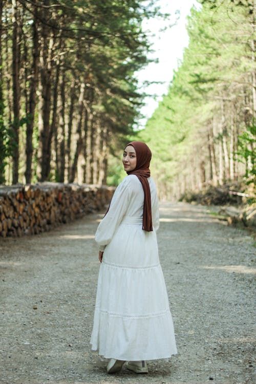 Woman in Hijab and Dress Posing in Forest