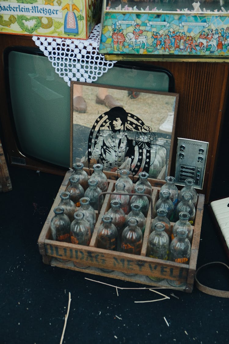 Wooden Crate Of Vintage Glass Bottles In A Thrift Store