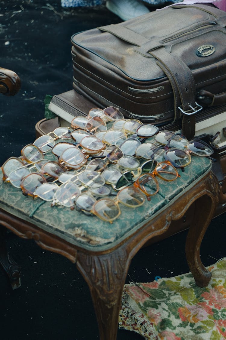 Vintage Eyeglasses Displayed On A Retro Stool At A Flea Market