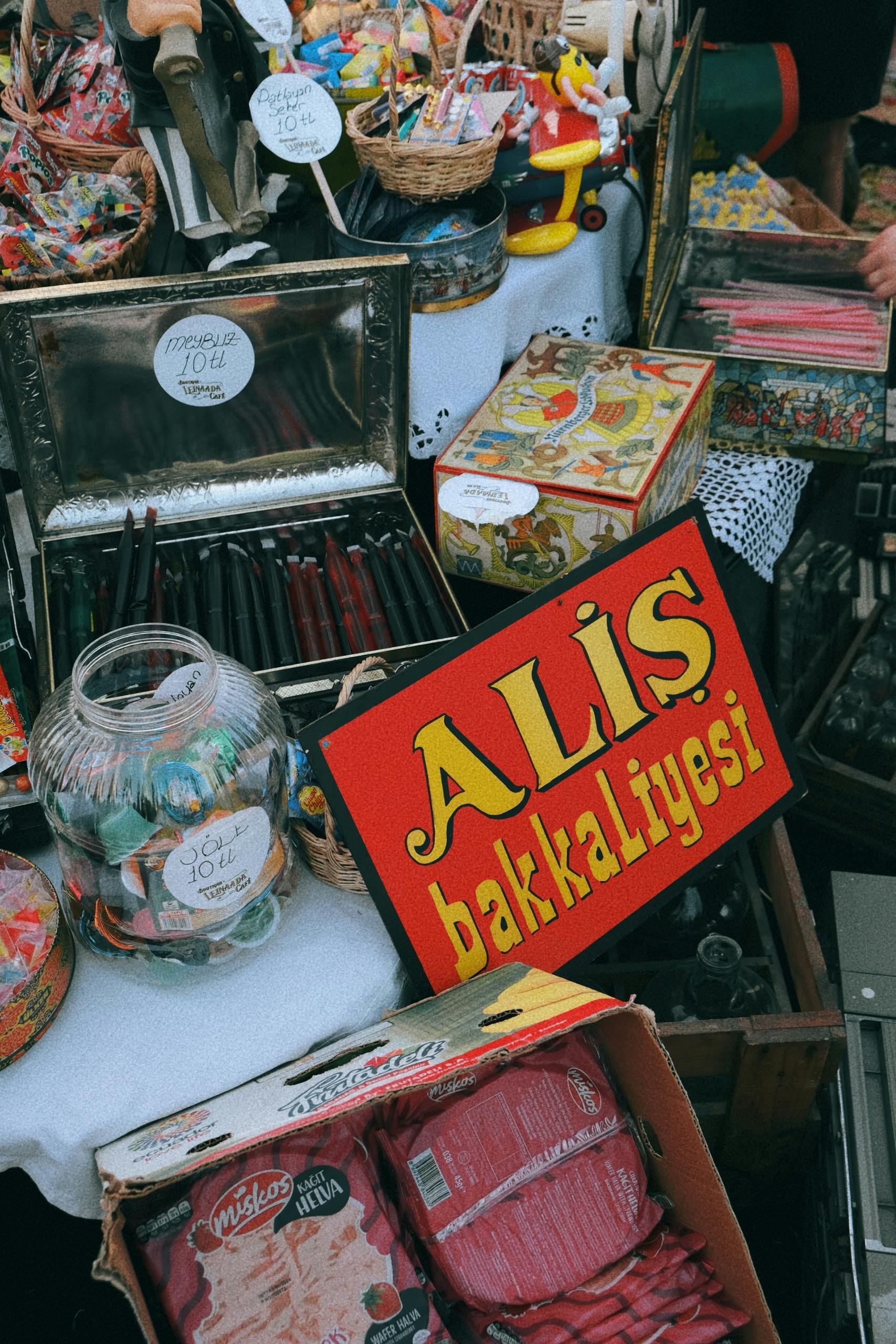 A vibrant close-up of a Turkish street market stall displaying various candies and accessories.