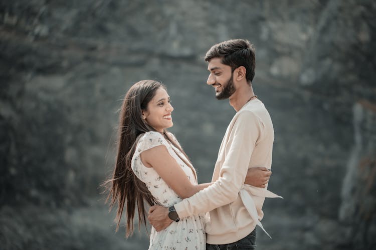 Smiling Couple Standing And Hugging