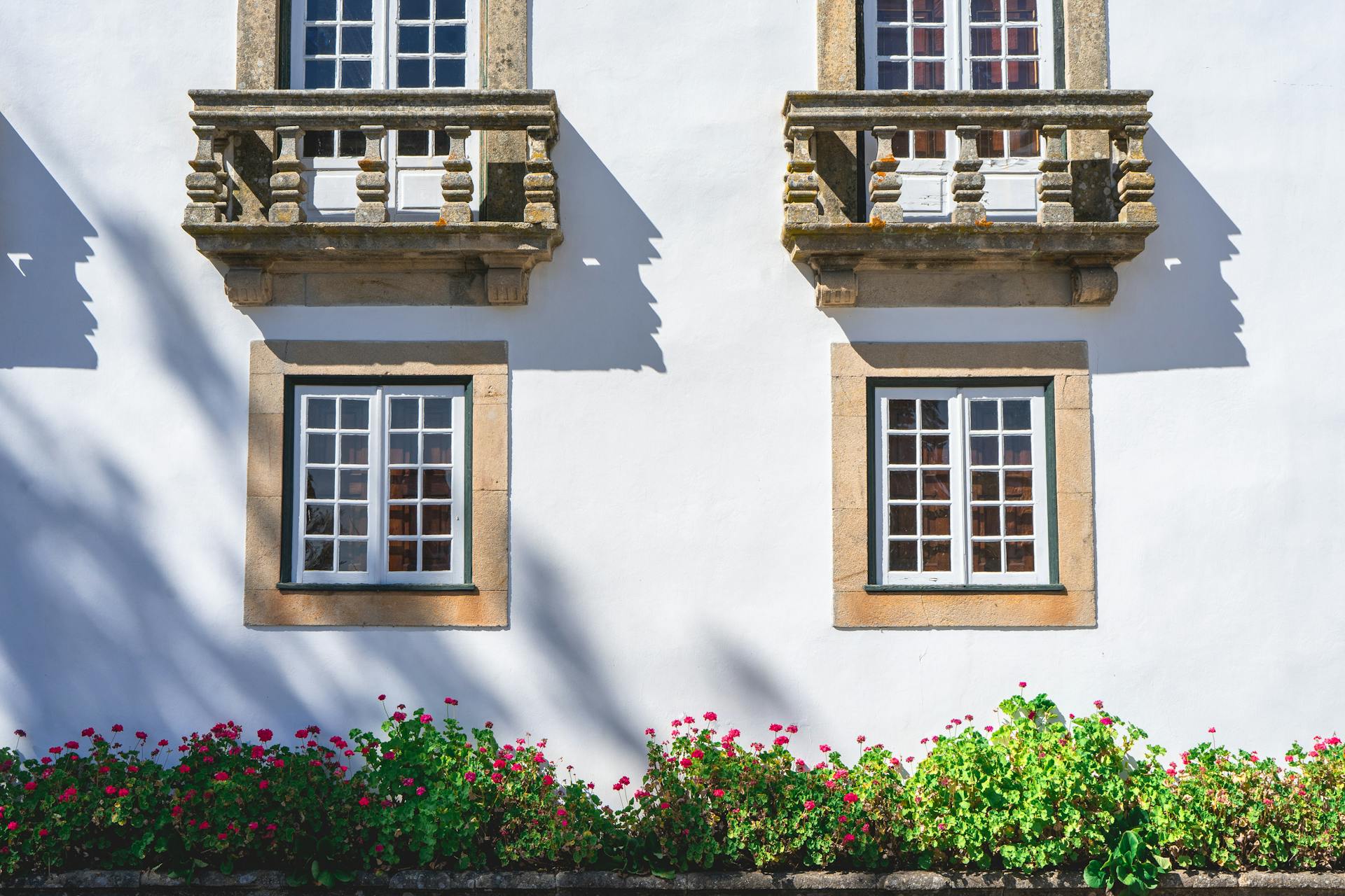 Portuguese architectural facade in Vila Real, Portugal with traditional stone balconies and window details.