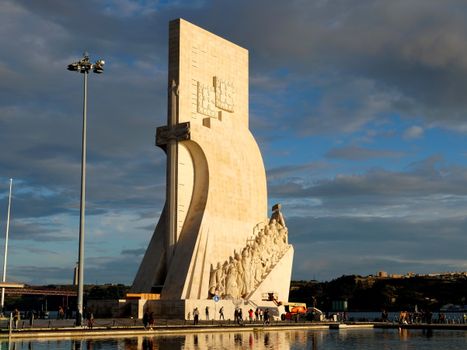 Padrão dos Descobrimentos monument in Lisbon, Portugal reflecting in water under a dramatic sky.
