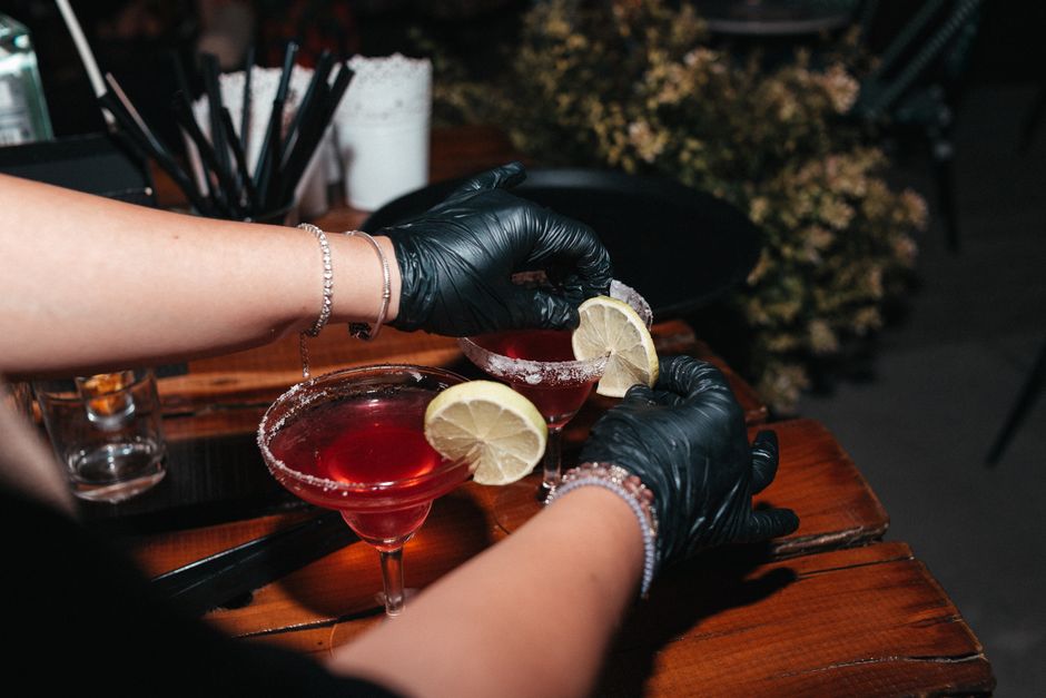 bartender crafting a signature cocktail with fresh ingredients and dramatic pour bartender crafting a signature cocktail with fresh ingredients and dramatic pour