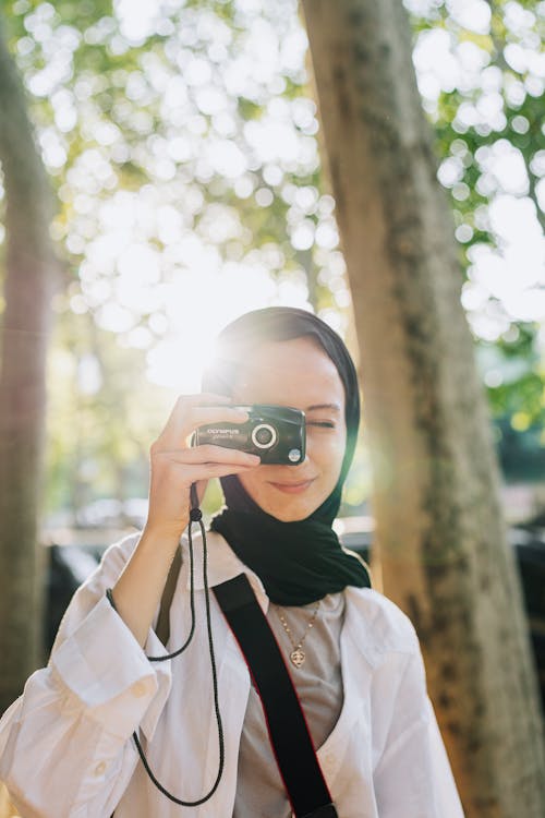 Woman in Hijab Taking Pictures with Camera