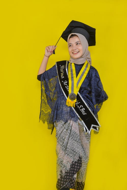 Smiling Graduate on Yellow Background