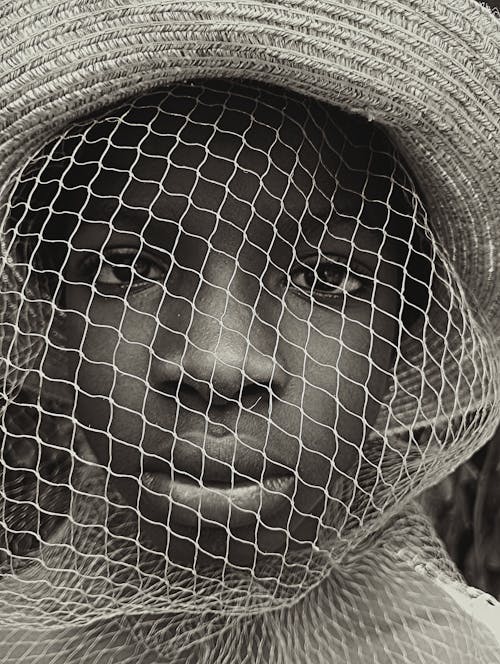 Portrait of Boy with Net on Face