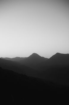 A tranquil black and white mountain landscape captured at dawn, emphasizing the natural beauty.