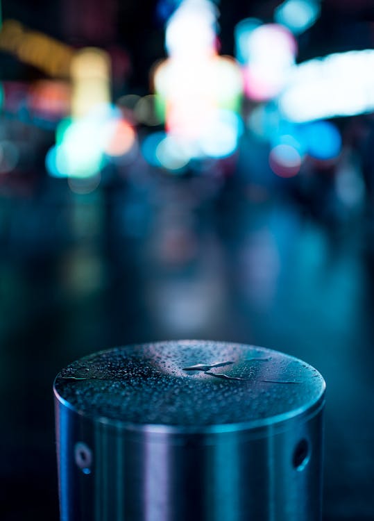 Round Silver Portable Speaker With Bokeh Photography
