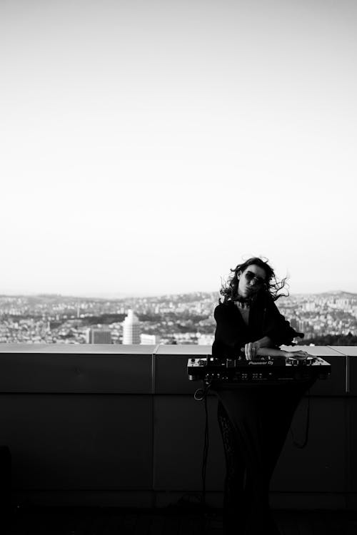 Woman Standing with Music Mixer near Wall