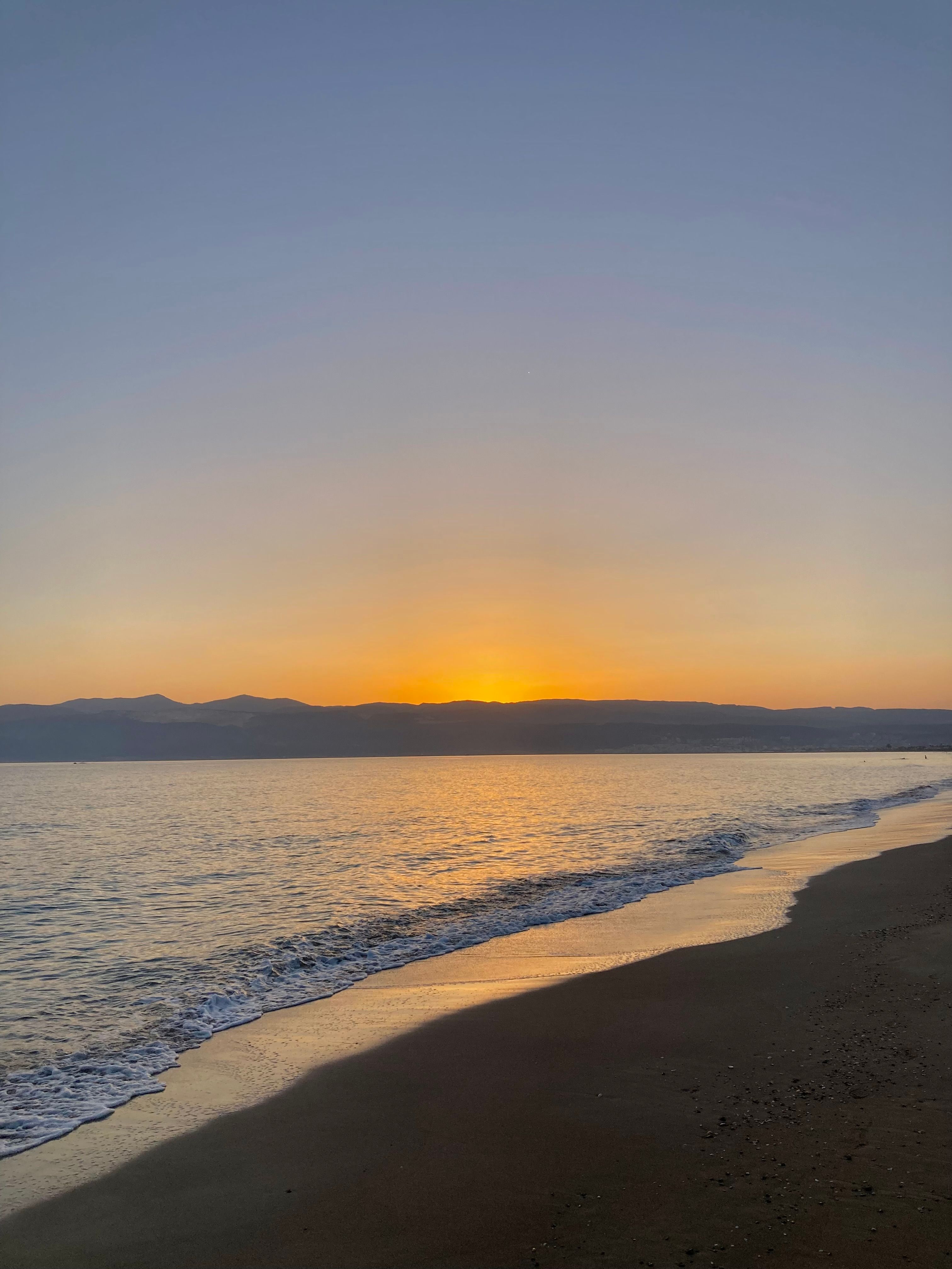 Sunset under Clear Sky over Sea Shore · Free Stock Photo