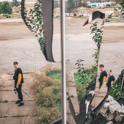 Man Standing on Pavement