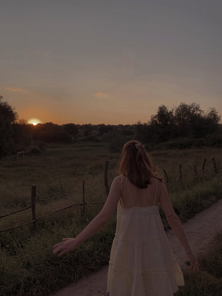 Woman On Country Road At Sunrise