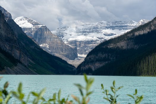 Stunning view of Lake Louise with mountains and glacier reflections in Banff National Park, Alberta, Canada.
