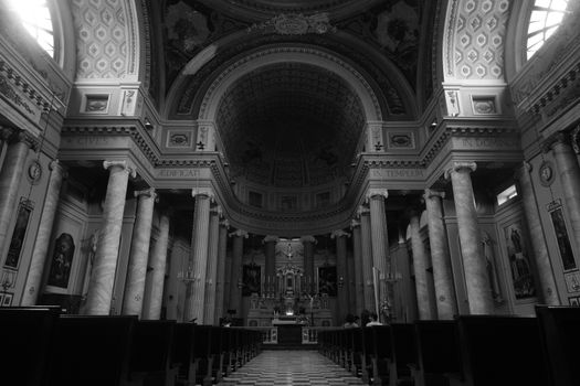 Monochrome interior of an Italian church featuring a central aisle and altar.