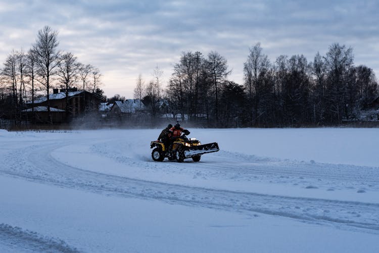 People Driving On A Truck In Snow