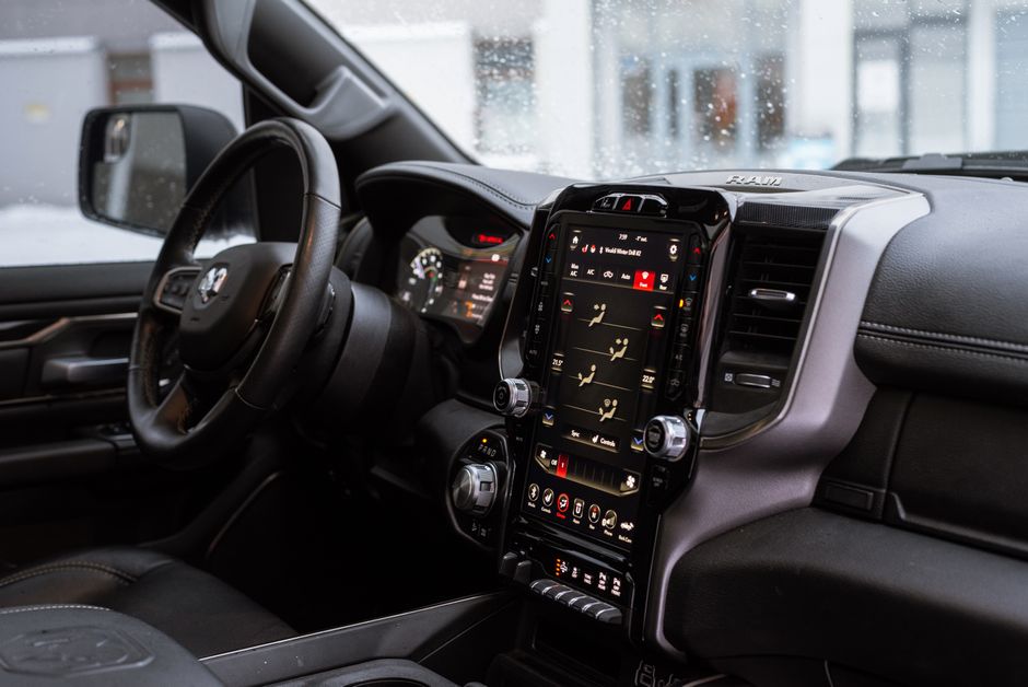 modern car interior large touchscreen versus physical climate buttons