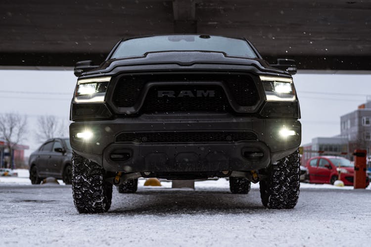 Low Angle Shot Of A Black RAM Pickup Truck On A Parking Lot