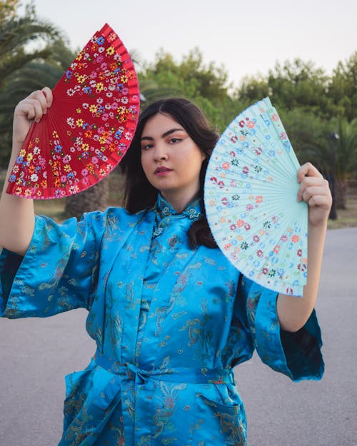 Model in a Blue Kimono with a Mandarin Collar Holding Hand Fans