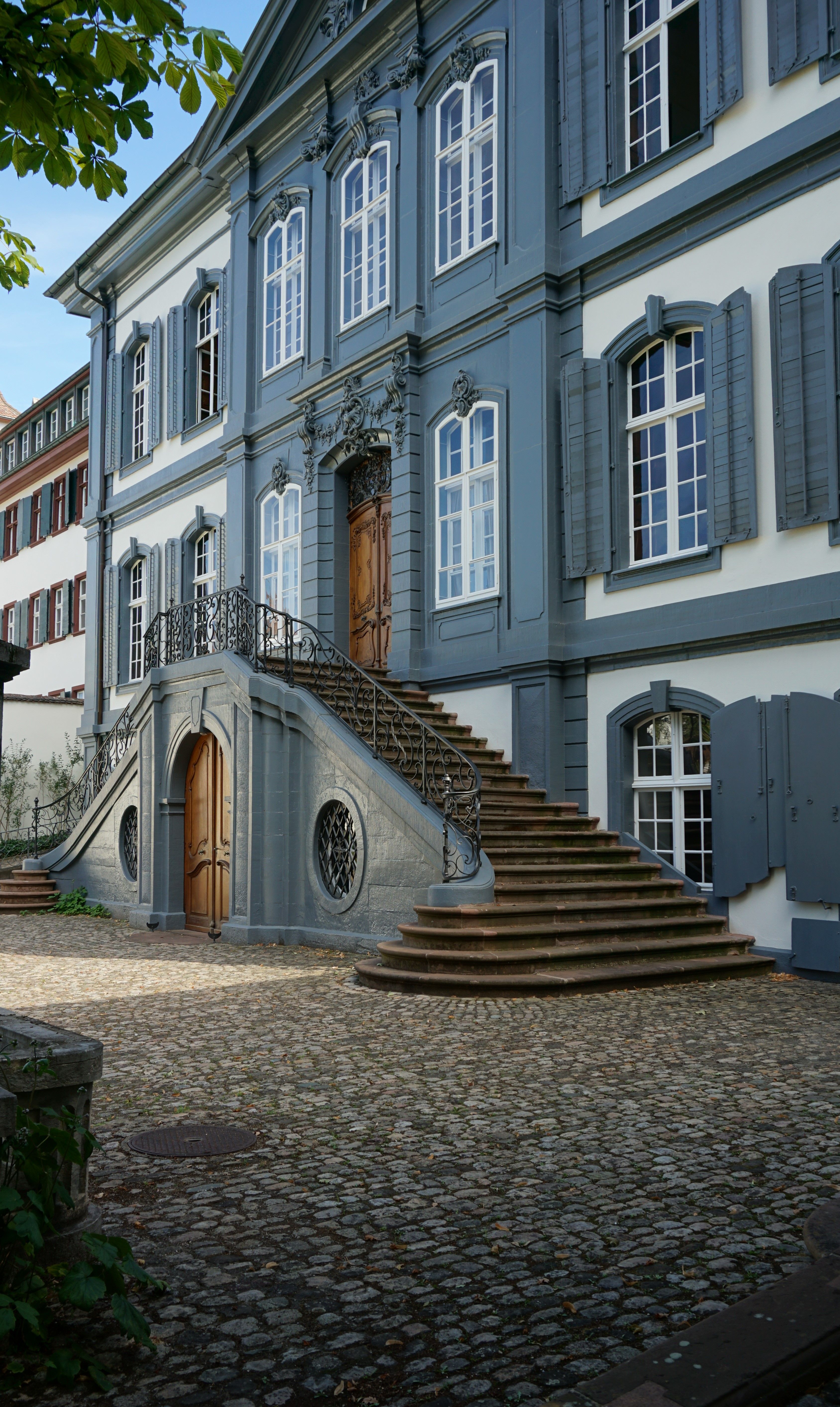 A blue building with stairs and a door · Free Stock Photo