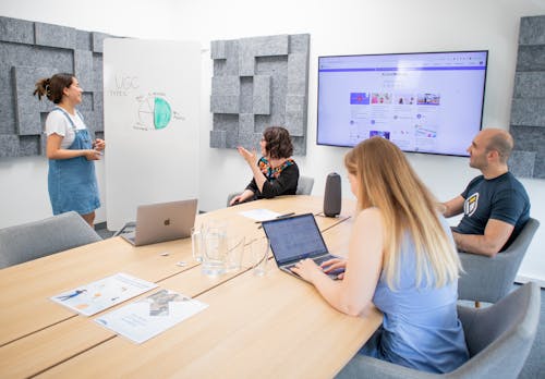 Employees Discussing Presentation at the Meeting in Conference Room