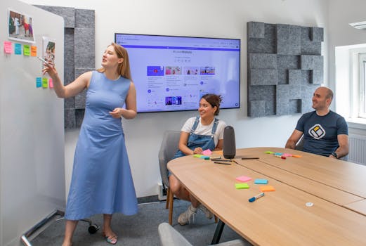 Three colleagues discussing ideas during a team meeting in a conference room.