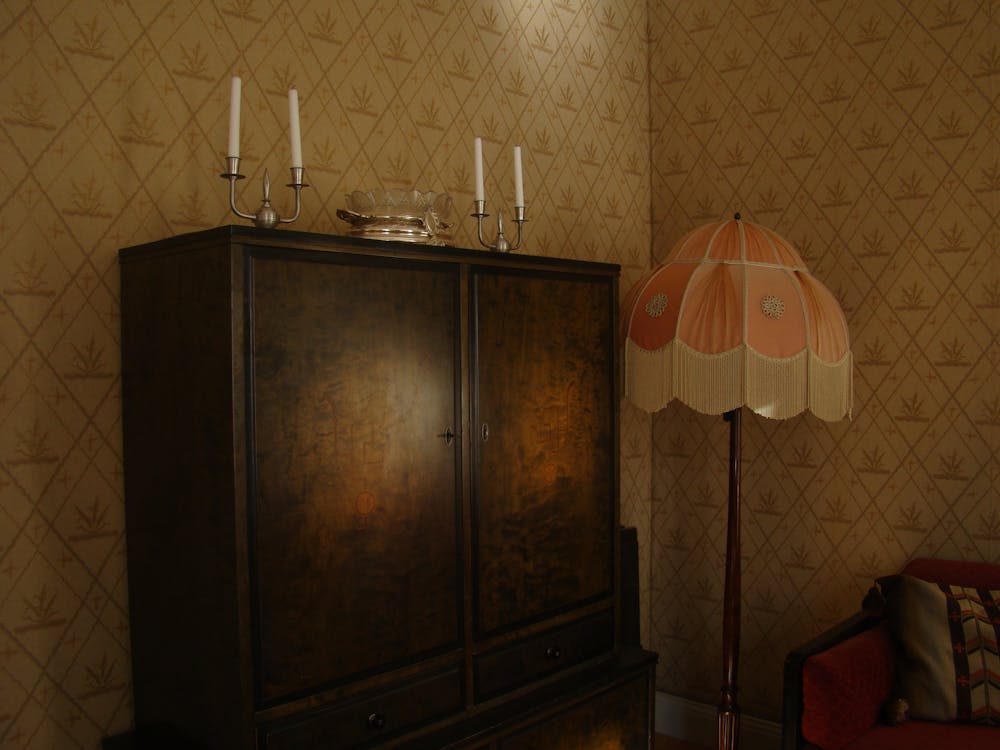 Candlesticks on Top of Antique Wooden Cabinet 