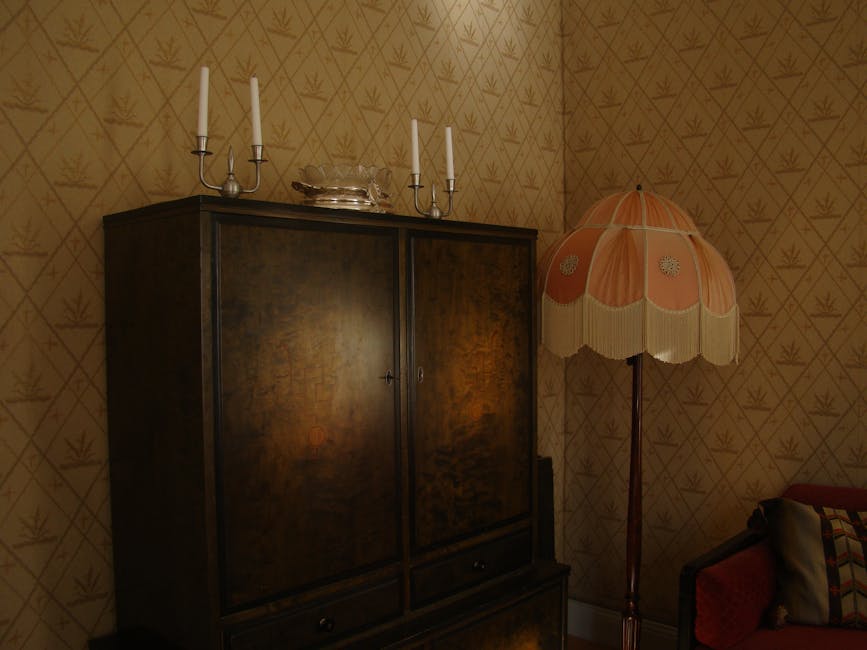 Black Wooden Wardrobe and White and Pink Pedestal Lamp Inside the Room