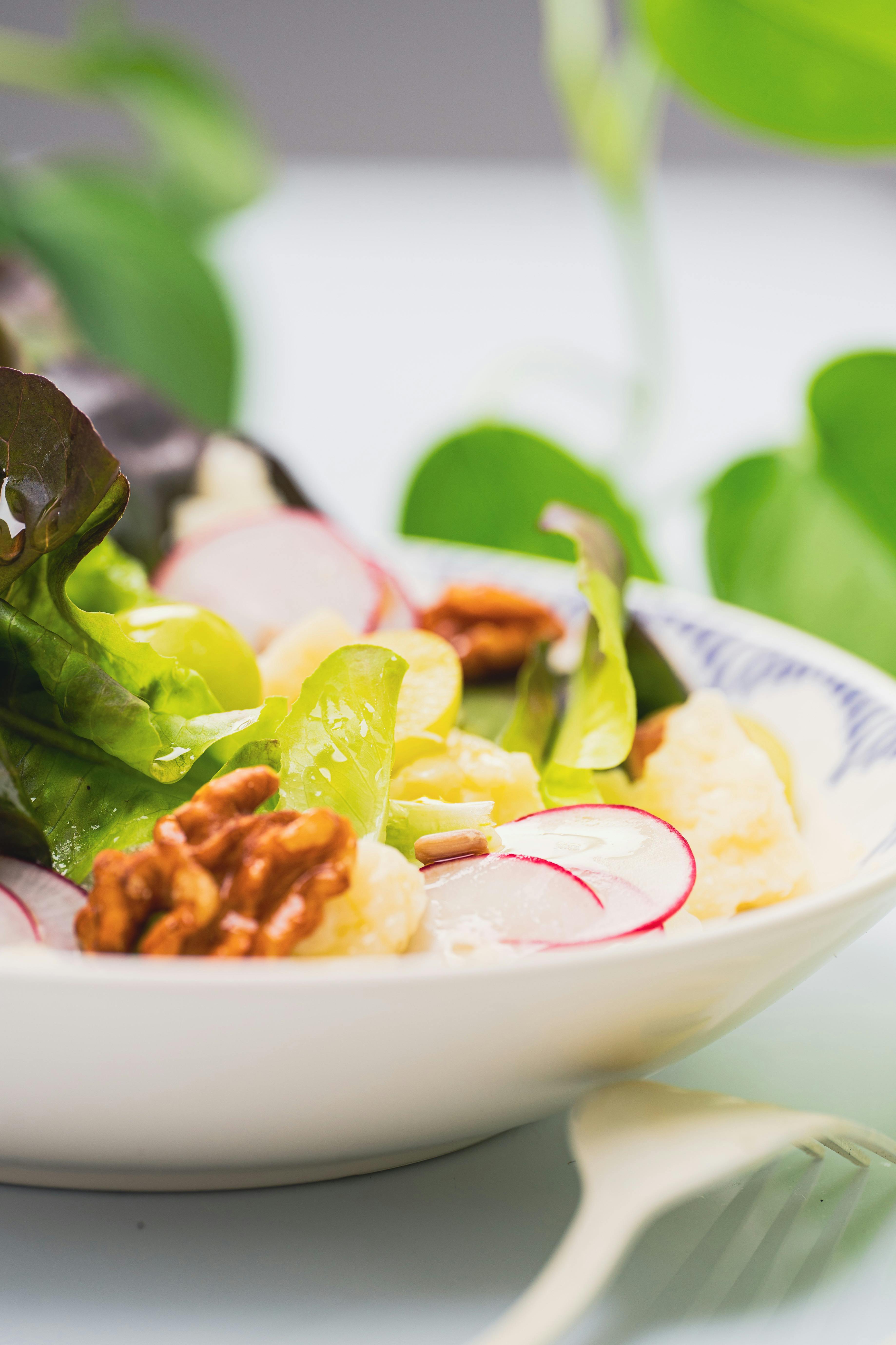 a salad with radishes lettuce and nuts