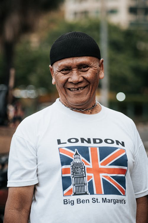 A man in a london shirt smiles for the camera