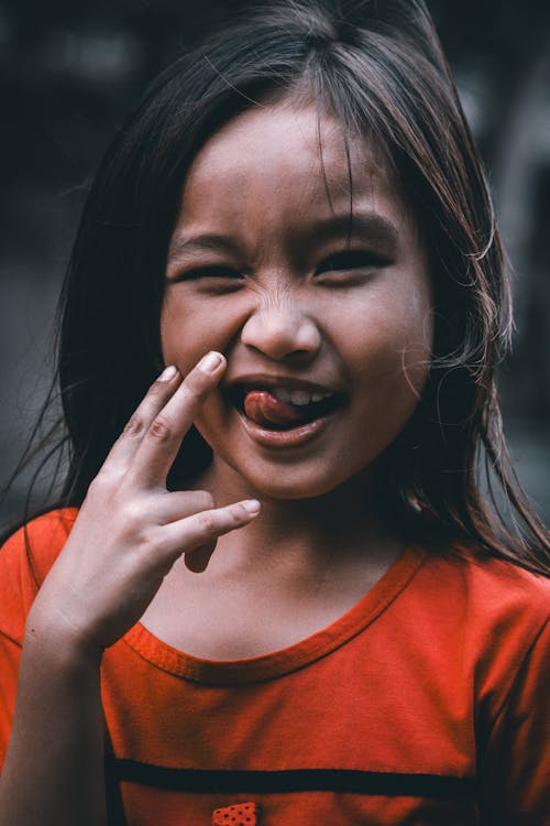 A young girl with her finger in her mouth