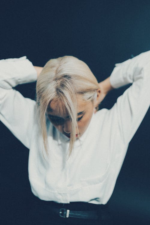 A woman with blonde hair and white shirt