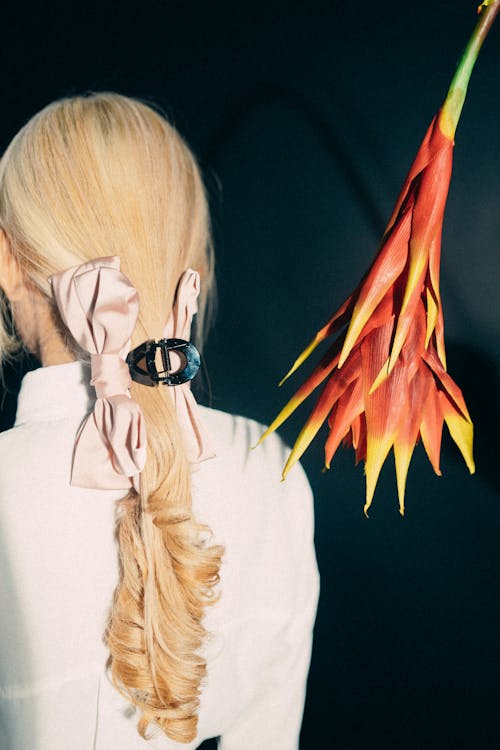 A blonde woman with a flower in her hair