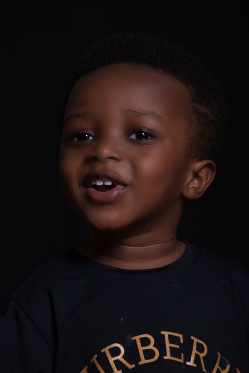 Free Portrait of a joyful child with afro hairstyle showing a playful expression. Stock Photo