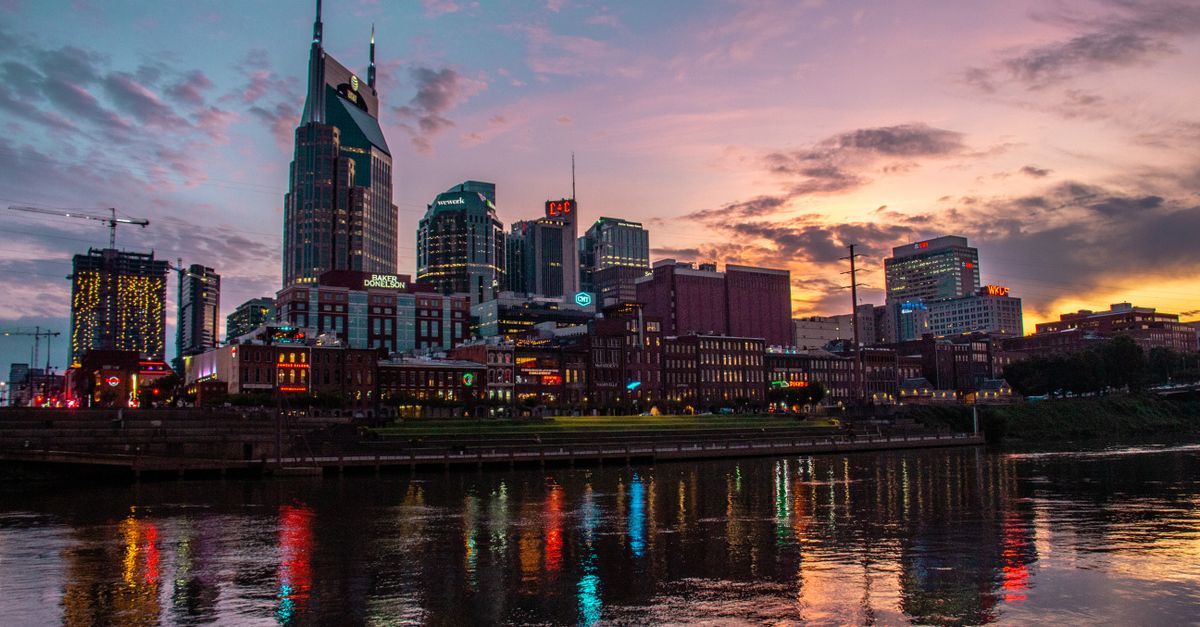 Captivating view of Nashville's skyline reflected on the river at sunset, showcasing urban architecture.