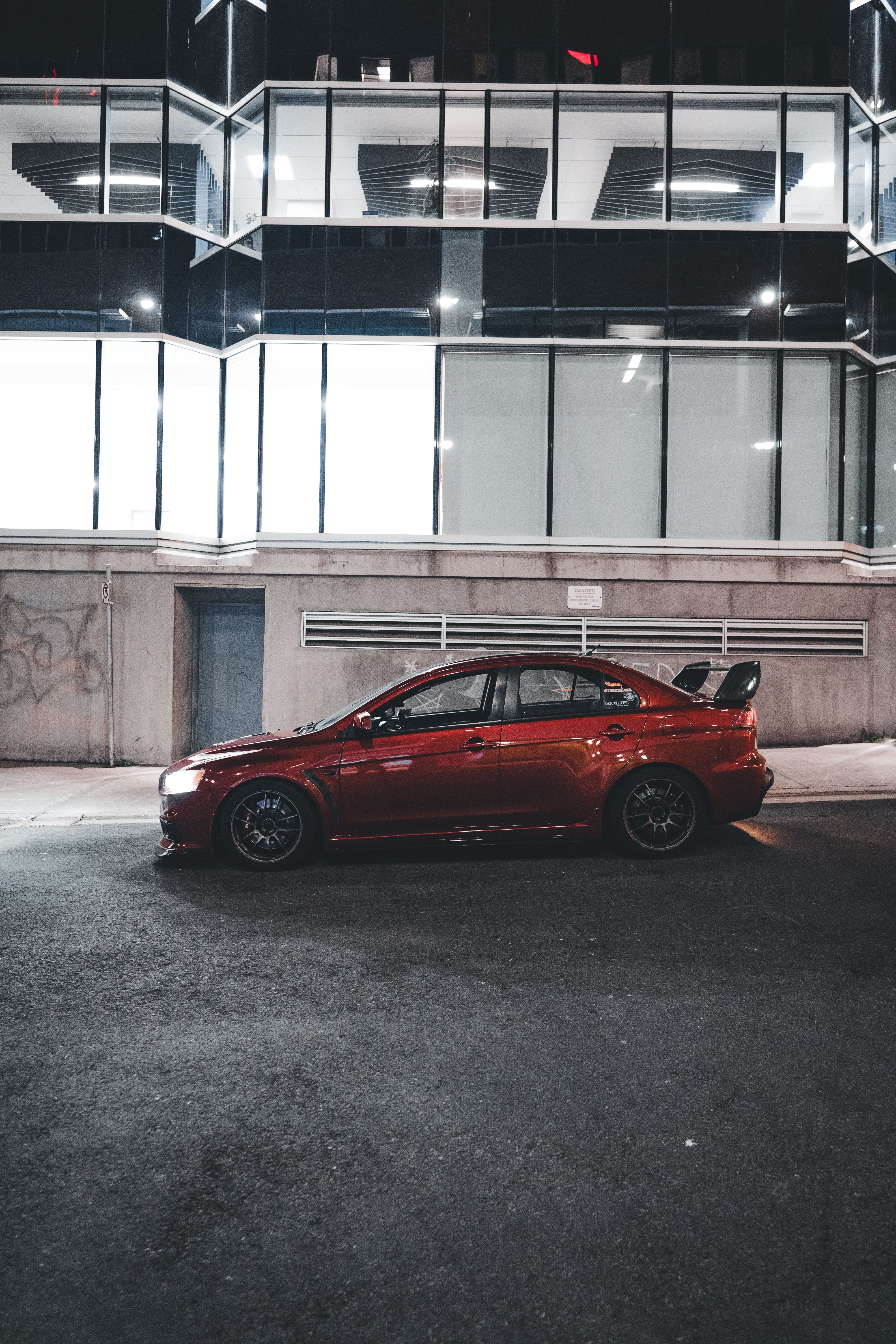 A red car parked in front of a building · Free Stock Photo