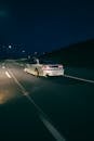 A car driving down the road at night