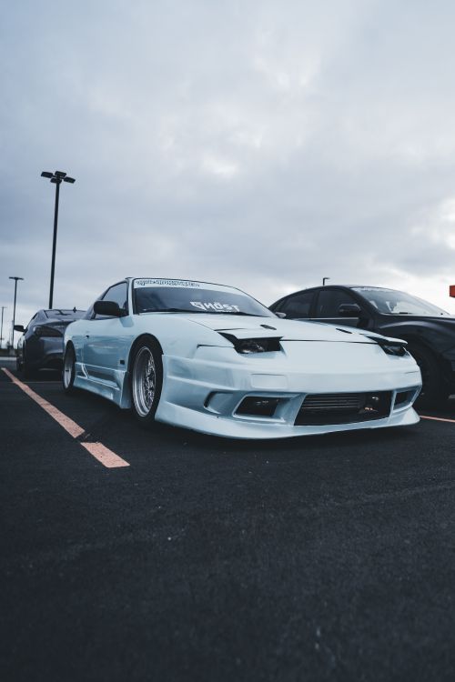 Free A stylish white sports car parked outdoors, emphasizing speed and design. Stock Photo
