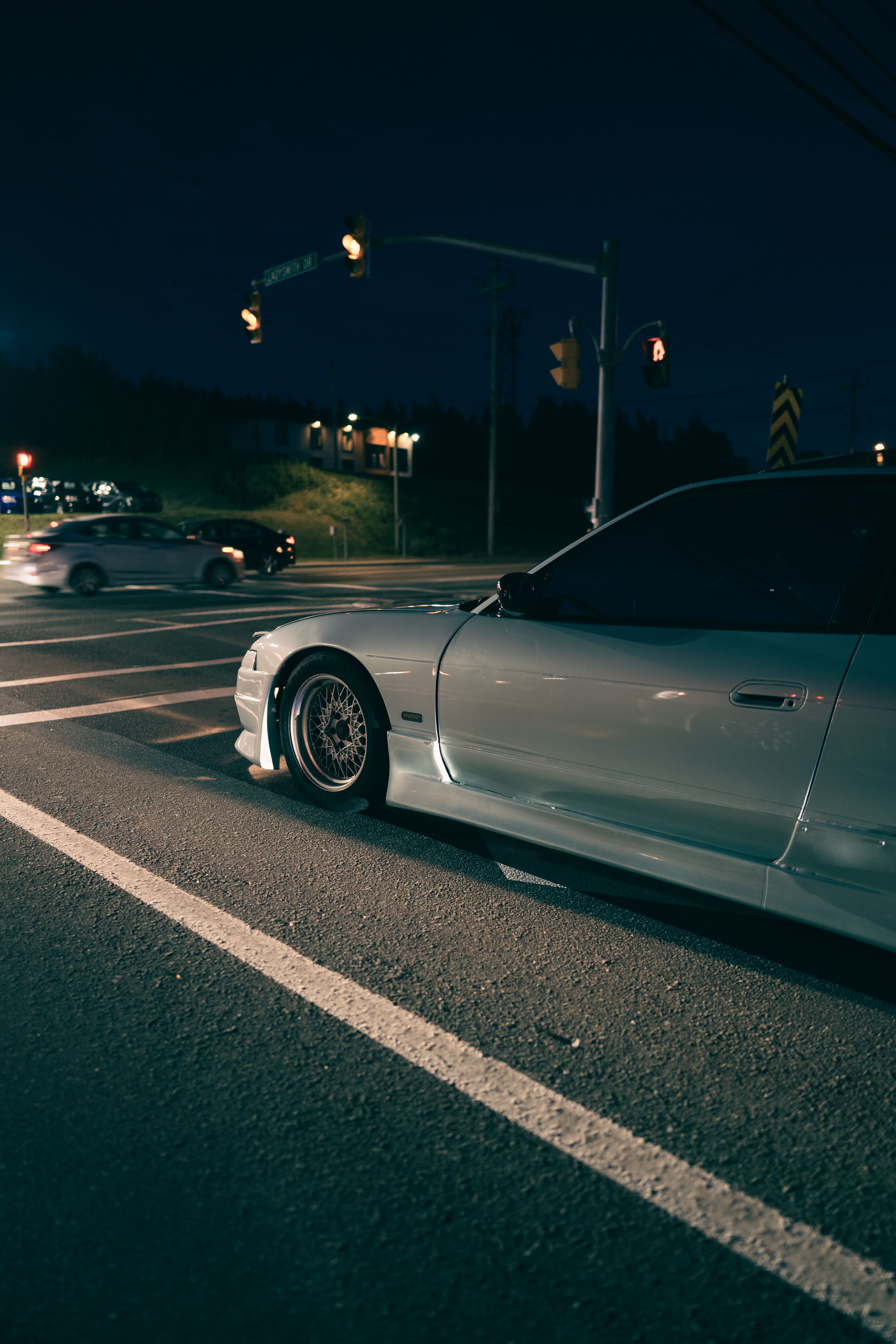 A car is parked on the street at night · Free Stock Photo