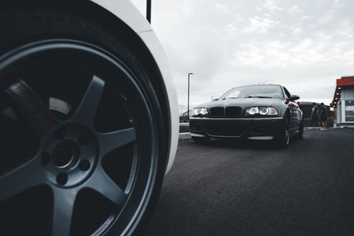 Free Dynamic shot of sleek sports cars on a wide asphalt road emphasizing power and speed. Stock Photo